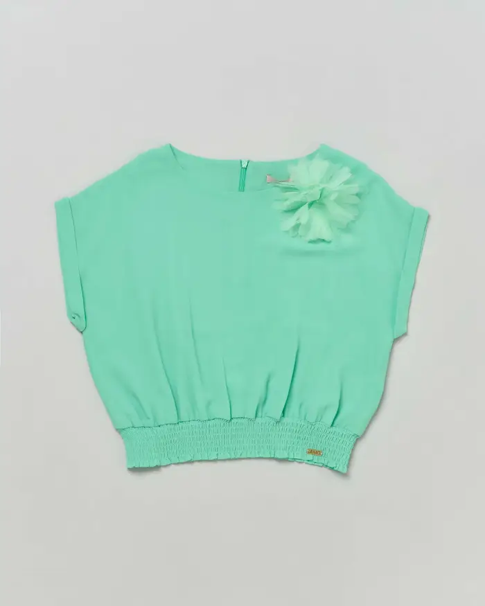 Blusa verde menta in crêpe con punto smock in vita e applicazione floreale